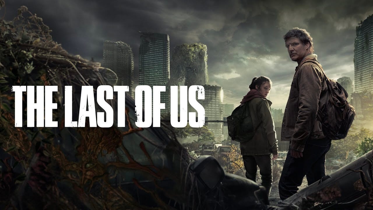 Joel (Pedro Pascal) and Ellie (Bella Ramsey) stare out at the ruins of a collapsed city in The Last of Us, amid a post-apocalyptic landscape.