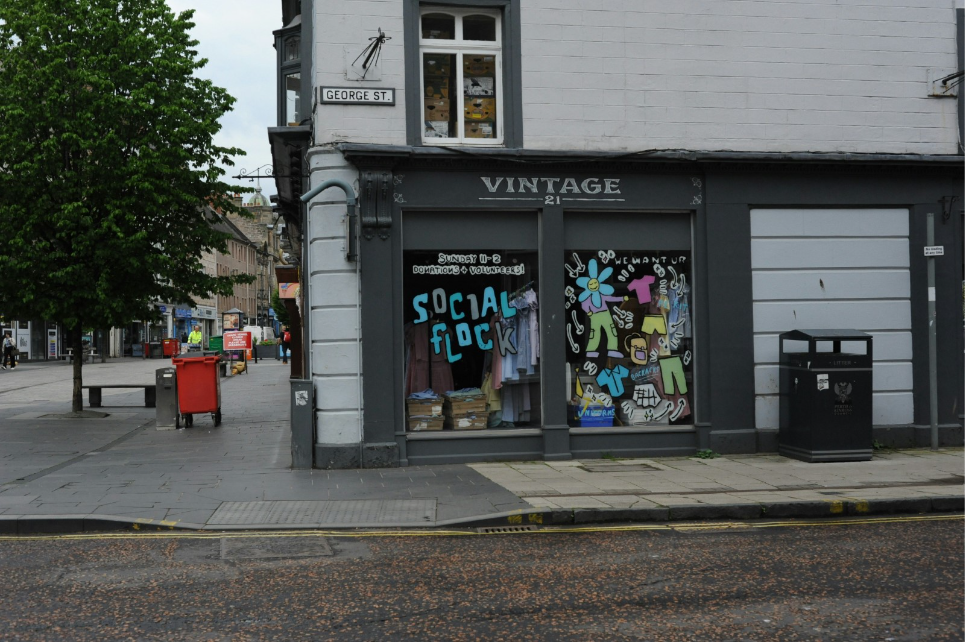 The text appears to be a street advertisement or promotional message for a vintage store or event, encouraging community engagement and volunteer participation.
AI-generated content may be incorrect.