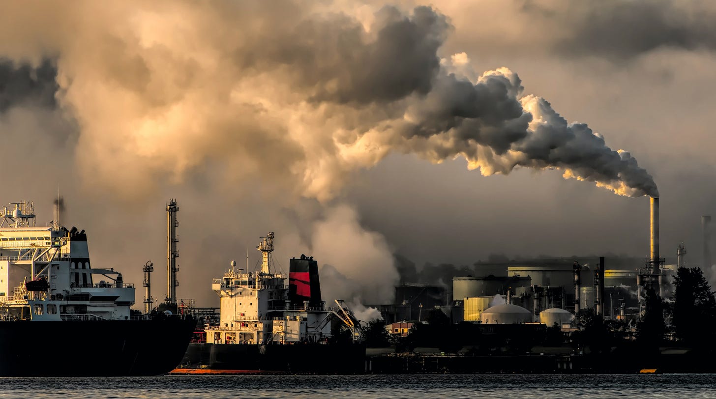 View of ships and factories with large amounts of pollutants spilling into the environment. Photo by Chris LeBoutillier from Pixabay