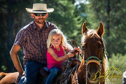Litlle cowgirl and ranching dad