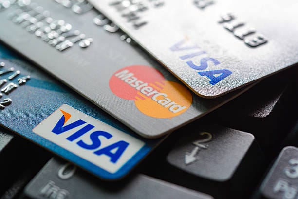 Group of credit cards on computer keyboard Bangkok, Thailand - Jun 23, 2015 : Group of credit cards on computer keyboard with VISA and MasterCard brand logos credit card banks stock pictures, royalty-free photos & images