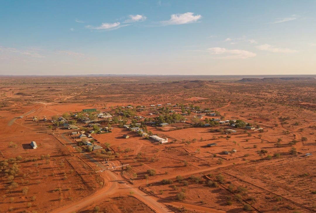 aerial view of brown field under blue sky during daytime aerial view of brown field under blue sky during daytime