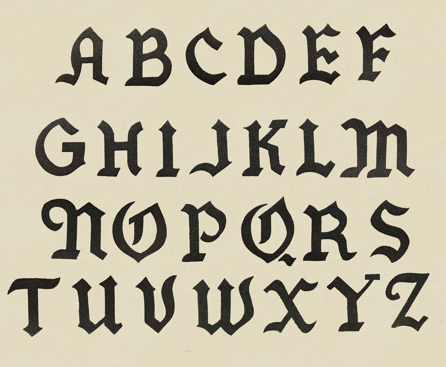 Black velvet-flocked Gothic alphabet on cream cardstock