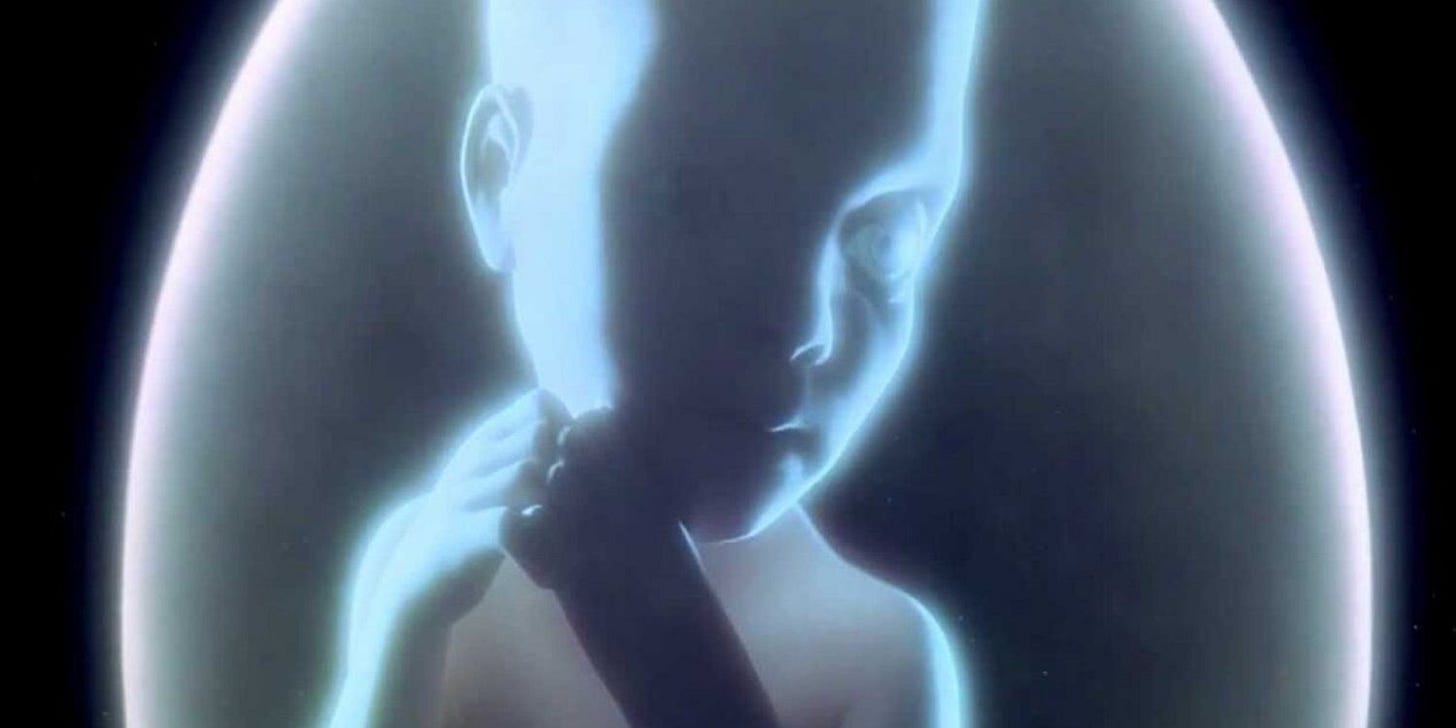 A glowing, ethereal fetus floats in a translucent orb against the blackness of space — the “Star Child” from 2001: A Space Odyssey. Its gaze is calm and contemplative, suggesting the emergence of a new consciousness.