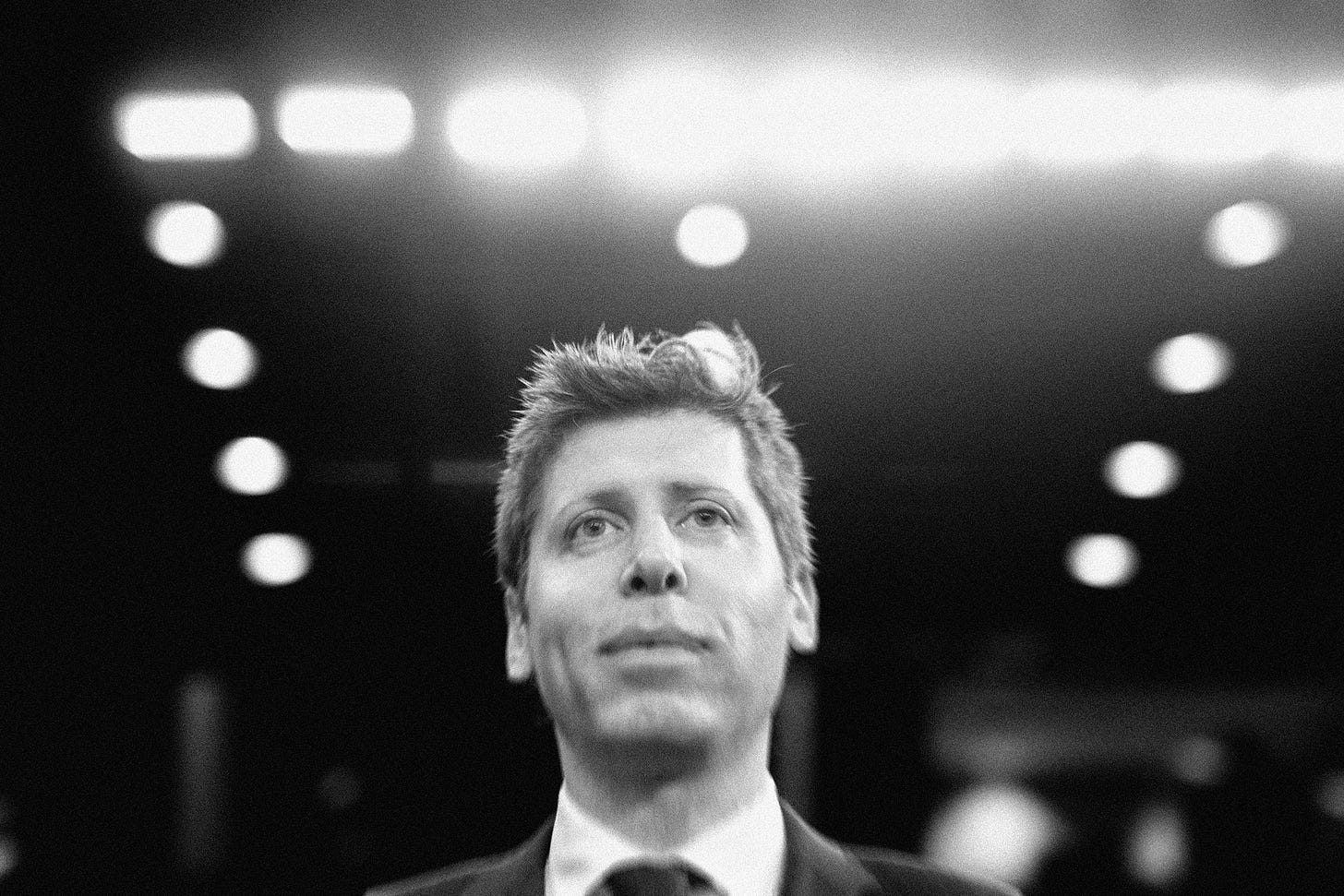 Image may contain Sam Altman Lighting Face Head Person Photography Portrait Adult Body Part Neck and Clothing