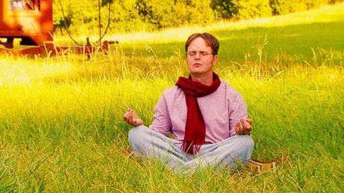 This may contain: a man sitting in the middle of a field with his eyes closed, meditating This may contain: a man sitting in the middle of a field with his eyes closed, meditating