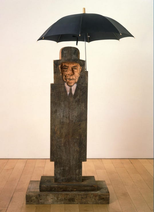 A wooden statue with a black umbrella

AI-generated content may be incorrect.