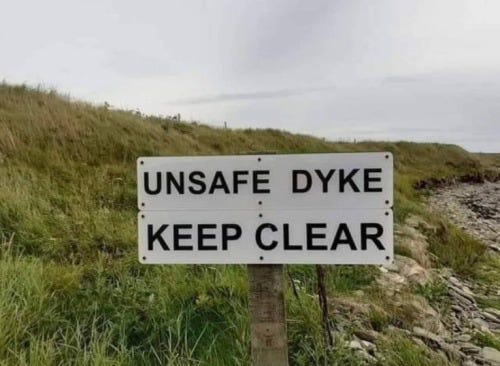 Animation Nerd — [a sign that reads "unsafe dyke" on a grassy dike]
