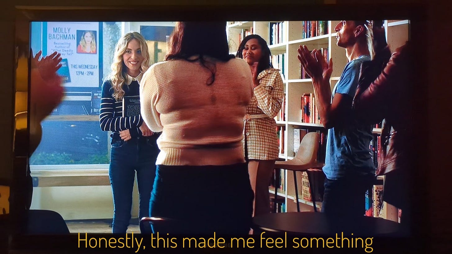 Molly, holding her book and receiving a standing ovation, captioned "Honestly, this made me feel something"
