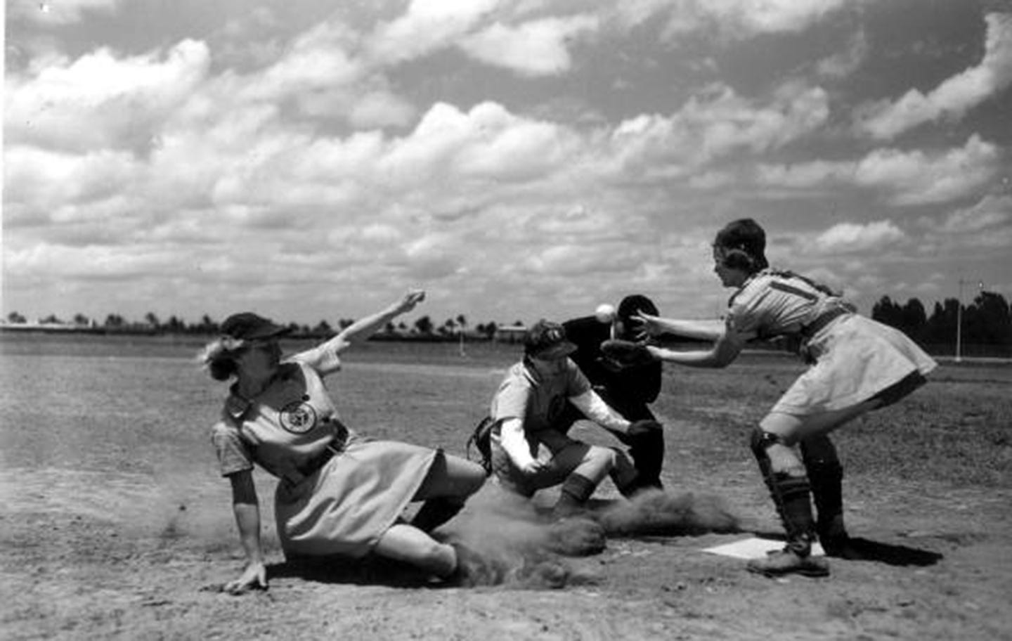 Members of the All-American Girls Professional Baseball League and an umpire, 1948. (Photo courtesy State Archives of Florida) Members of the All-American Girls Professional Baseball League and an umpire, 1948. (Photo courtesy State Archives of Florida)