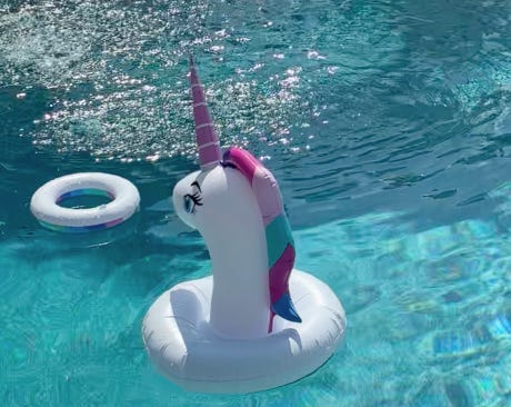 Picture of a unicorn in a pool of water.