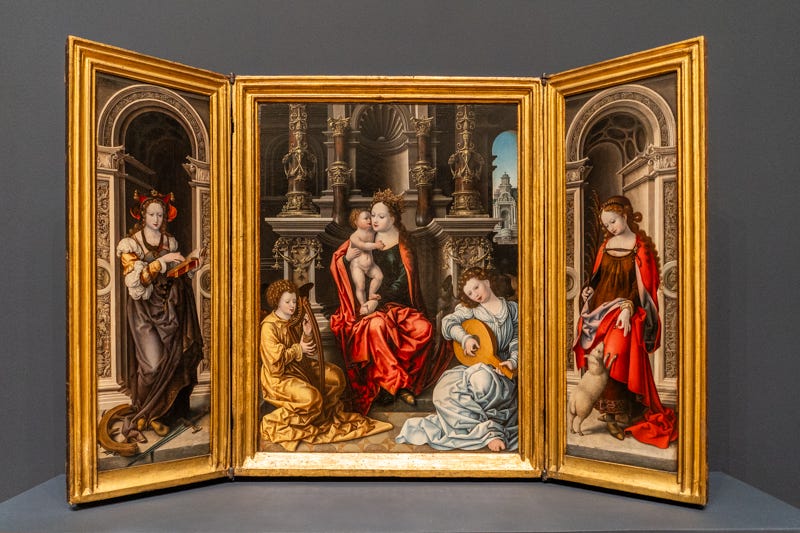 A three-part altarpiece of Mary and child with angels, and side panels of St Catherine and St Agnes