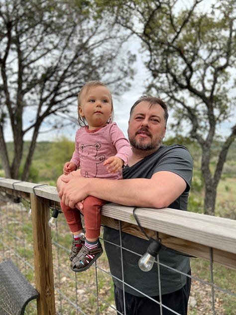 Han is sitting on a fence and Mike is holding him. They are having many sweet, affectionate, silly moments.