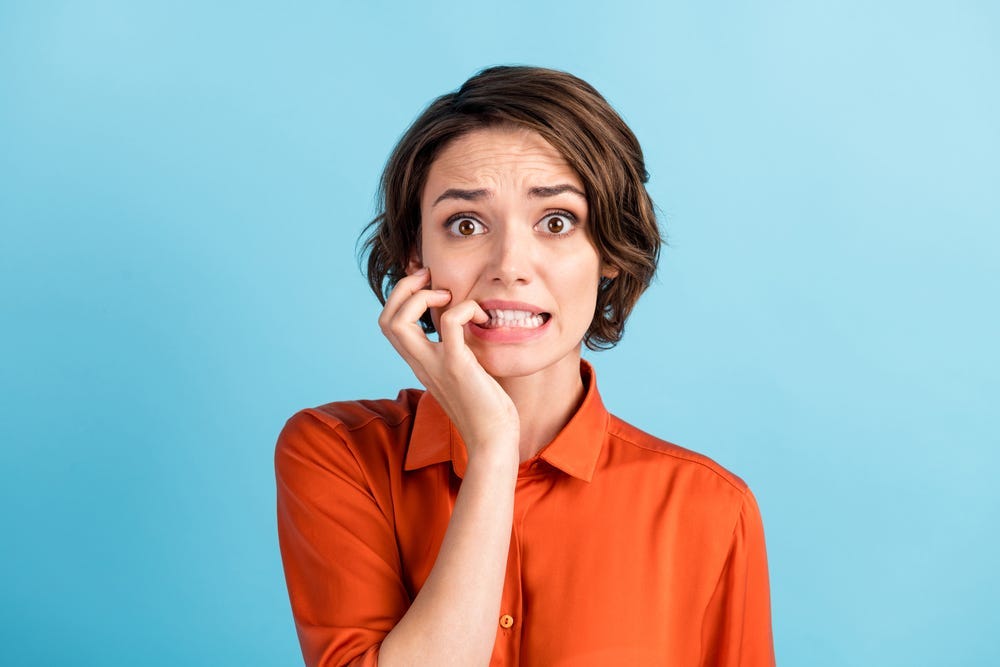 stock photo of woman looking guilty and worried