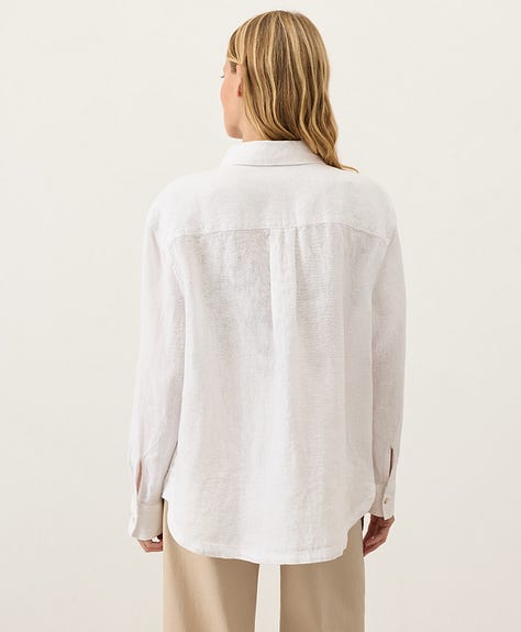 Various views of a model wearing the white longsleeve buttonfront linen shirt.