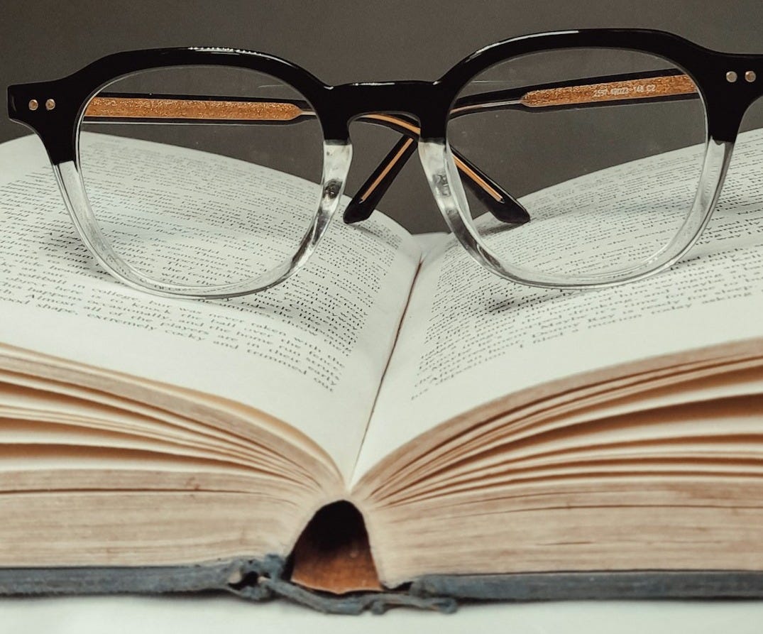 black framed eyeglasses on book page black framed eyeglasses on book page