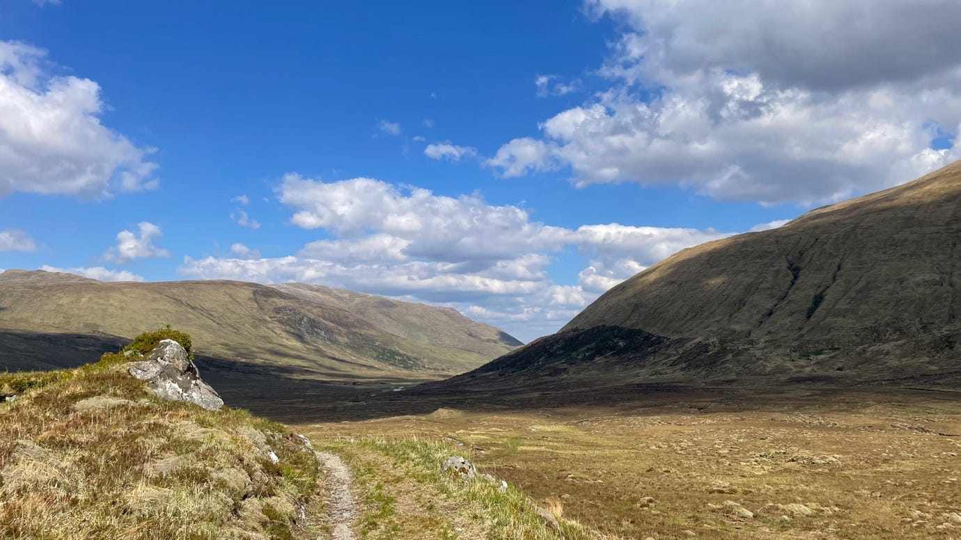 A dirt road leading to a mountain

AI-generated content may be incorrect.