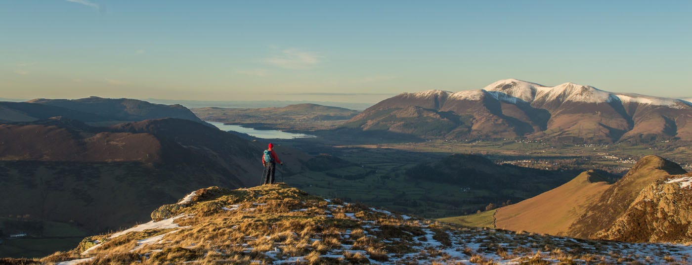 me in red jacket looking at snowy mountains