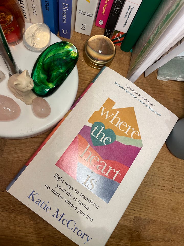 copies of a book with a colourful house shape on the cover