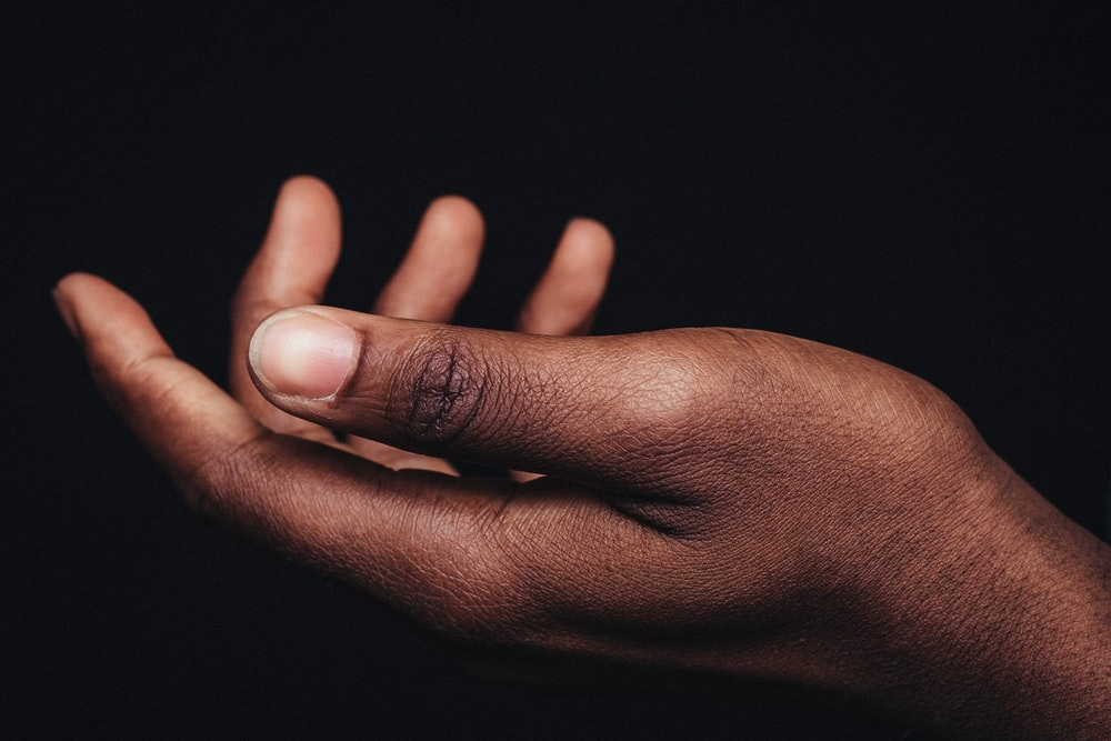 persons hand on black background persons hand on black background