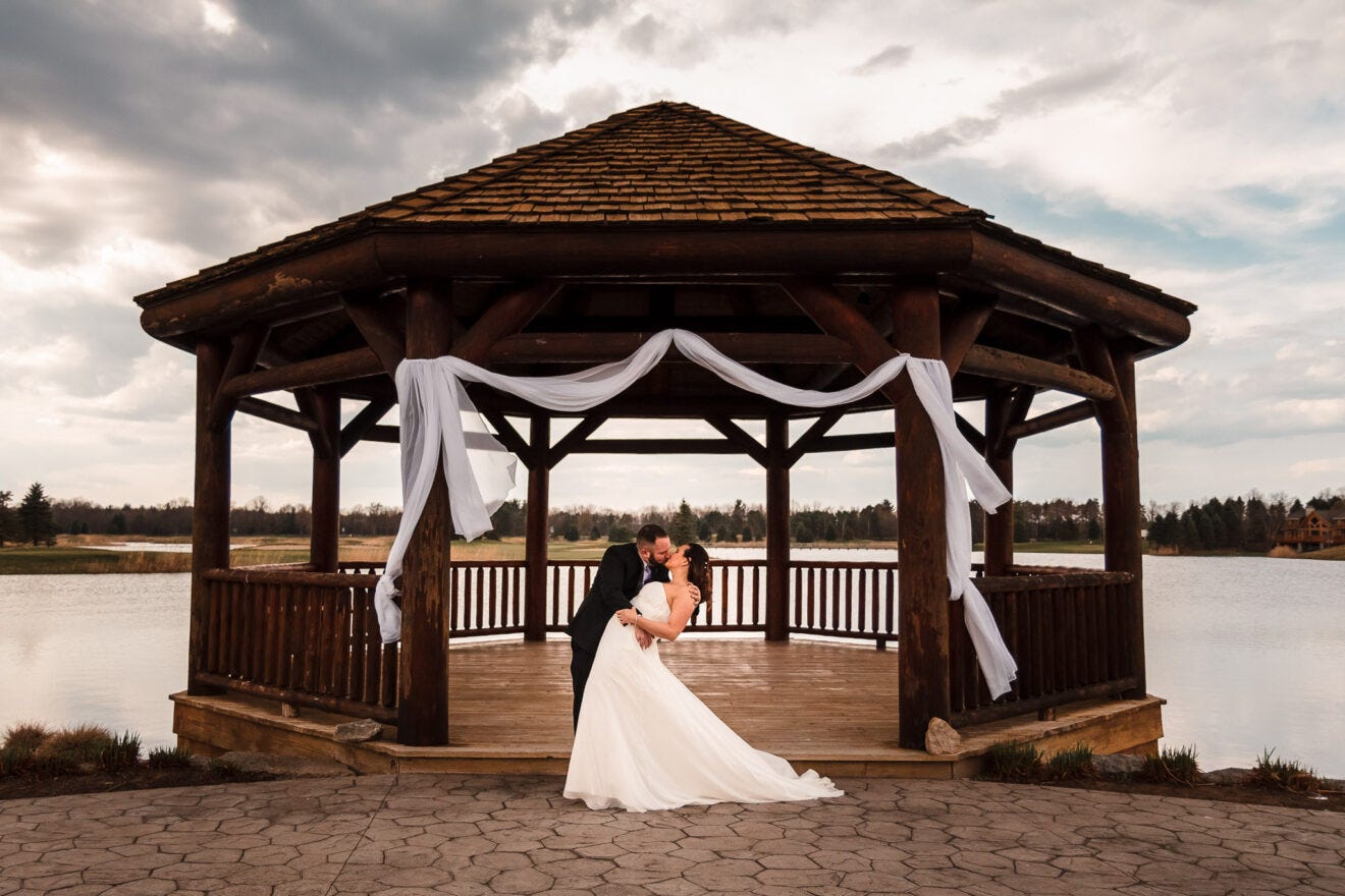 bride and groom dip and kiss, part of the event photography guide