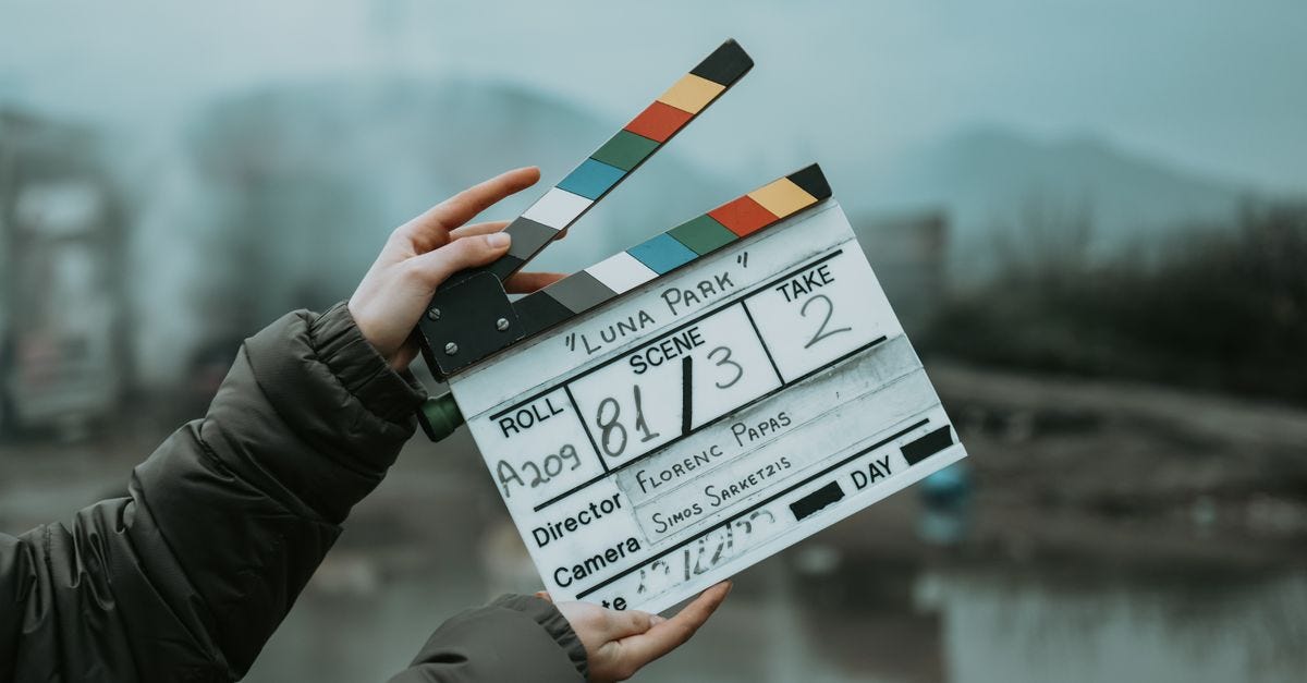 Photo: Erik Uruci / Pexels Close-up of a film clapperboard on an outdoor set, signaling scene start.