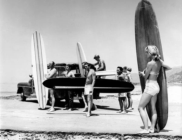 Members of the North Bay surfing club unload their boards from a station wagon at Malibu Beach, California, July 12, 1961. Members of the North Bay surfing club unload their boards from a station wagon at Malibu Beach, California, July 12, 1961.