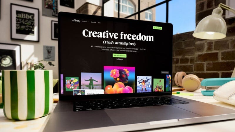 A laptop displaying a website with the headline "Creative freedom" sits on a cluttered desk with a green-striped mug, lamp, plants, and books in a bright, modern workspace. A laptop displaying a website with the headline "Creative freedom" sits on a cluttered desk with a green-striped mug, lamp, plants, and books in a bright, modern workspace.