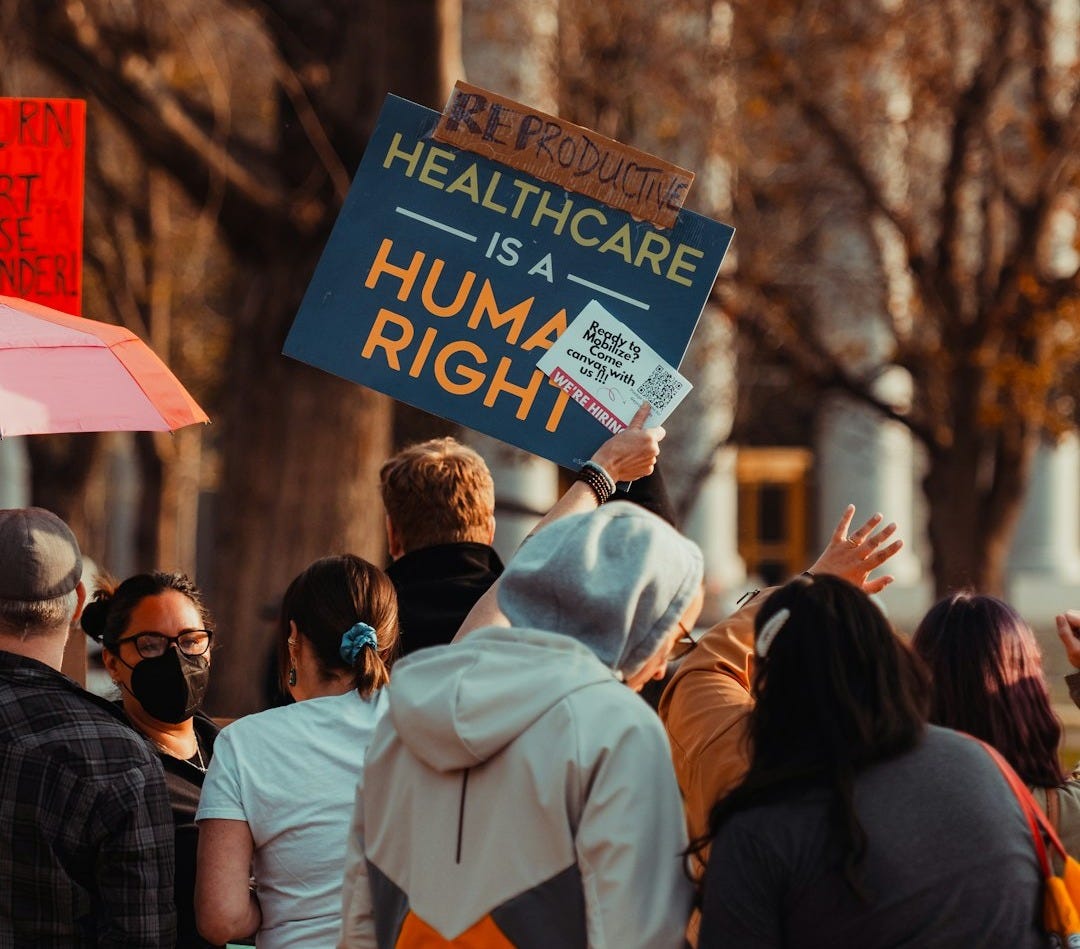 a group of people holding signs