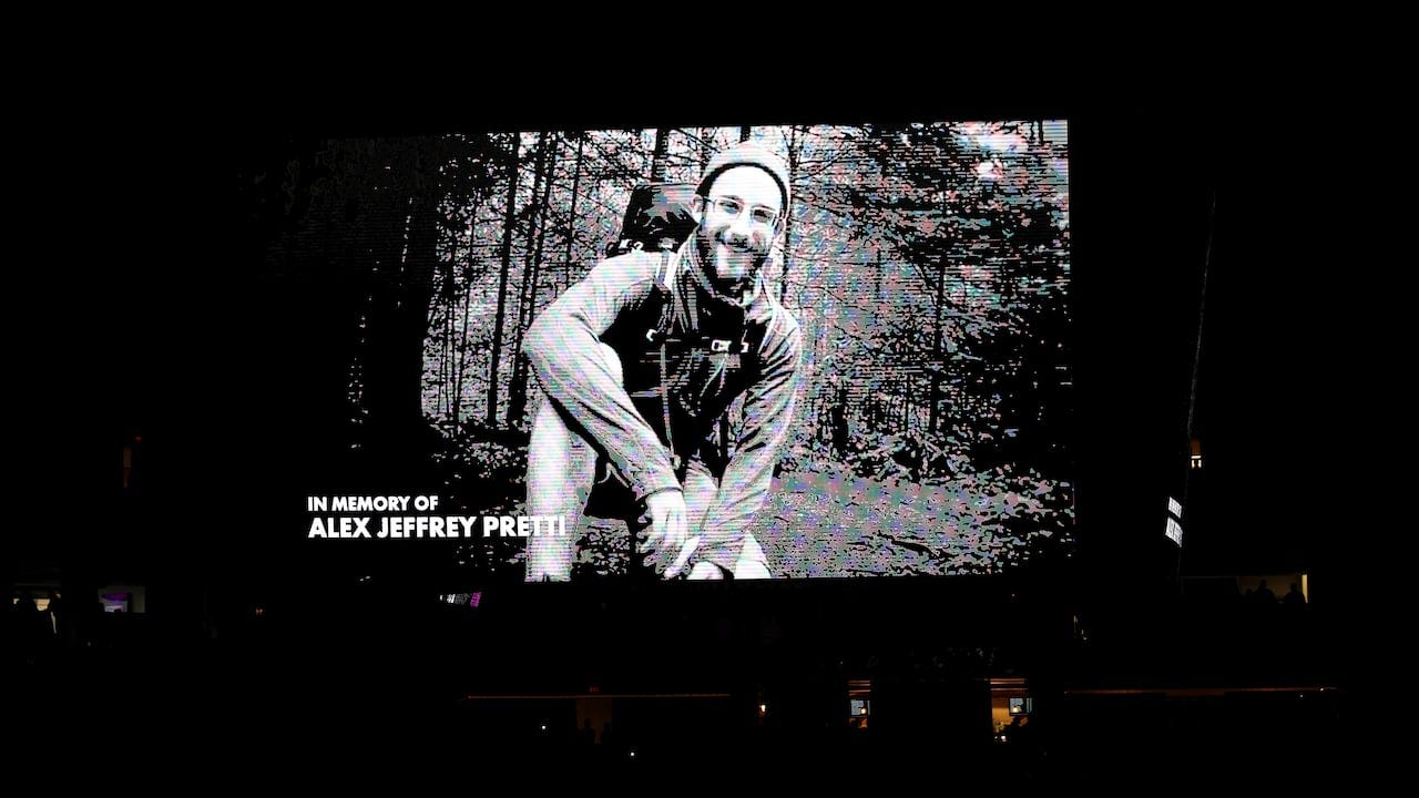 An in memoriam image is shown on a jumbotron.