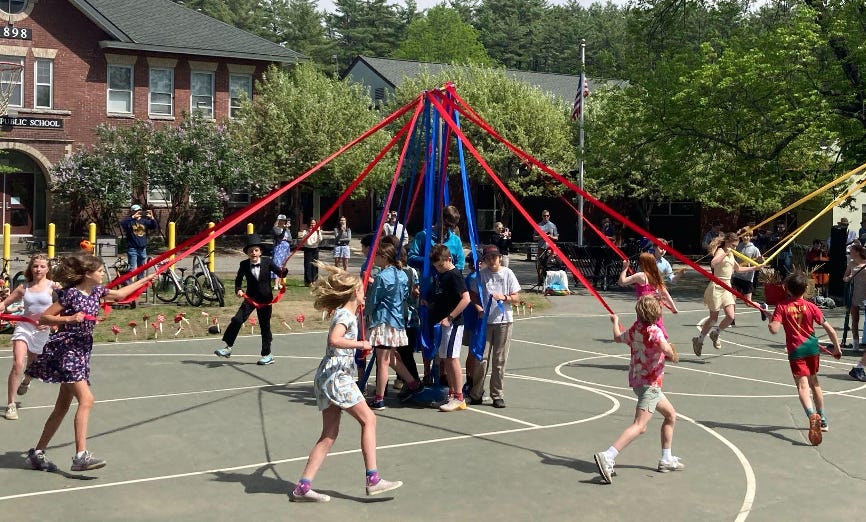 Sixth Grade students dancing around the May Pole