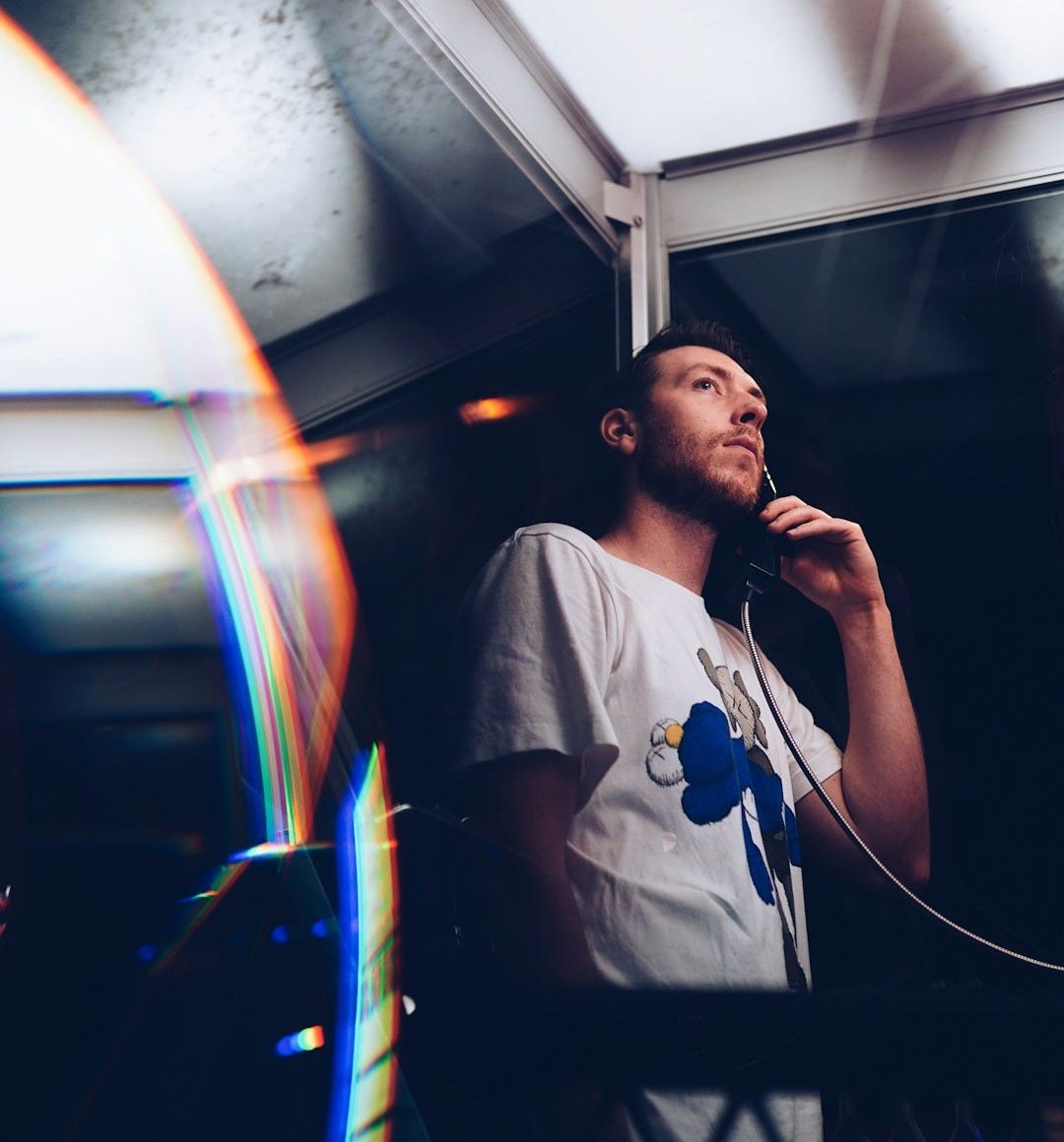 man in telephone booth at nighttime