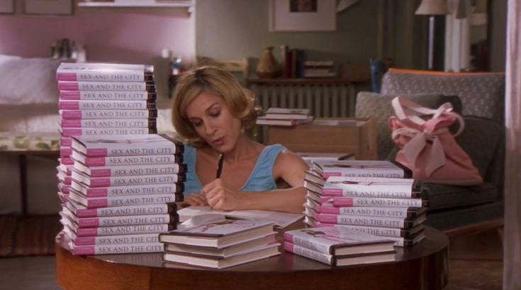 This may contain: a woman sitting at a table with stacks of books in front of her and writing