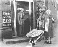 Wheelbarrow full of money outside of Fiest Bank in Germany Weimar Republic