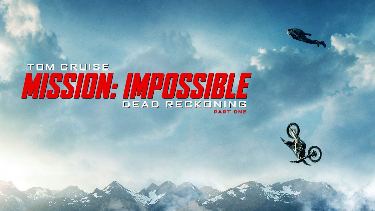 Tom Cruise flying over a tumbling motorbike.