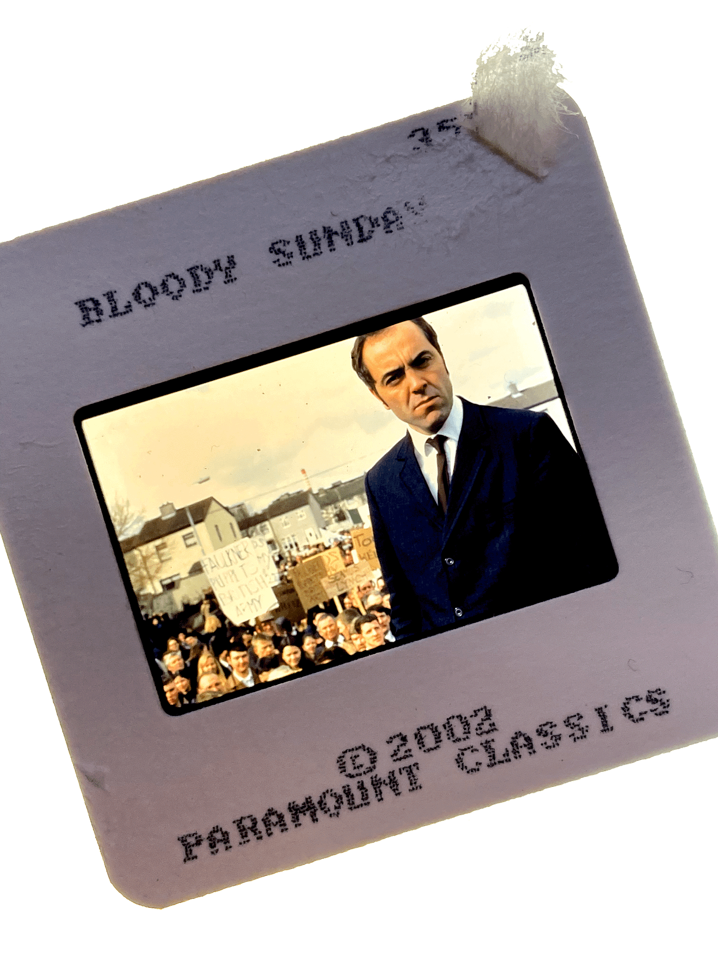 A color slide from BLOODY SUNDAY. Shows James Nesbitt standing in front of a group of protesters. A color slide from BLOODY SUNDAY. Shows James Nesbitt standing in front of a group of protesters.