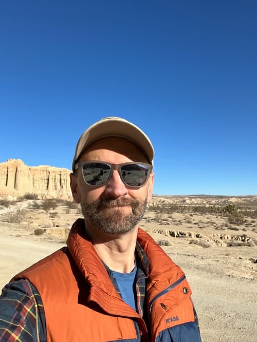A person wearing sunglasses and a hat

Description automatically generated with low confidence
