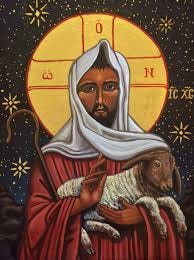An icon in traditional style of Jesus with brown skin and dark hair and beard, holding a lamb.