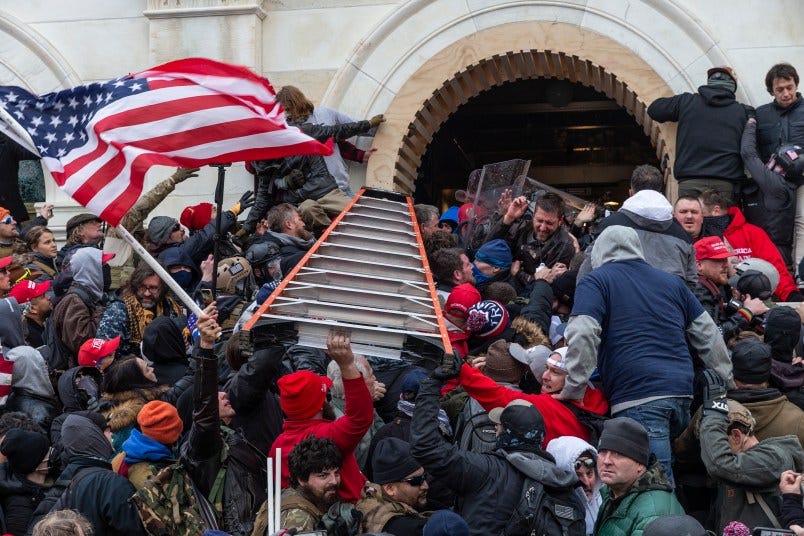 WASHINGTON DC, DISTRICT OF COLUMBIA, UNITED STATES - 2021/01/06: Rioters clash with police using big ladder trying to enter Capitol building through the front doors. Rioters broke windows and breached the Capitol building in an attempt to overthrow the results of the 2020 election. Police used batons and tear gas grenades to eventually disperse the crowd. Rioters used metal bars and tear gas as well against the police. (Photo by Lev Radin/Pacific Press/LightRocket via Getty Images) WASHINGTON DC, DISTRICT OF COLUMBIA, UNITED STATES - 2021/01/06: Rioters clash with police using big ladder trying to enter Capitol building through the front doors. Rioters broke windows and breached the Capitol building in an attempt to overthrow the results of the 2020 election. Police used batons and tear gas grenades to eventually disperse the crowd. Rioters used metal bars and tear gas as well against the police. (Photo by Lev Radin/Pacific Press/LightRocket via Getty Images)