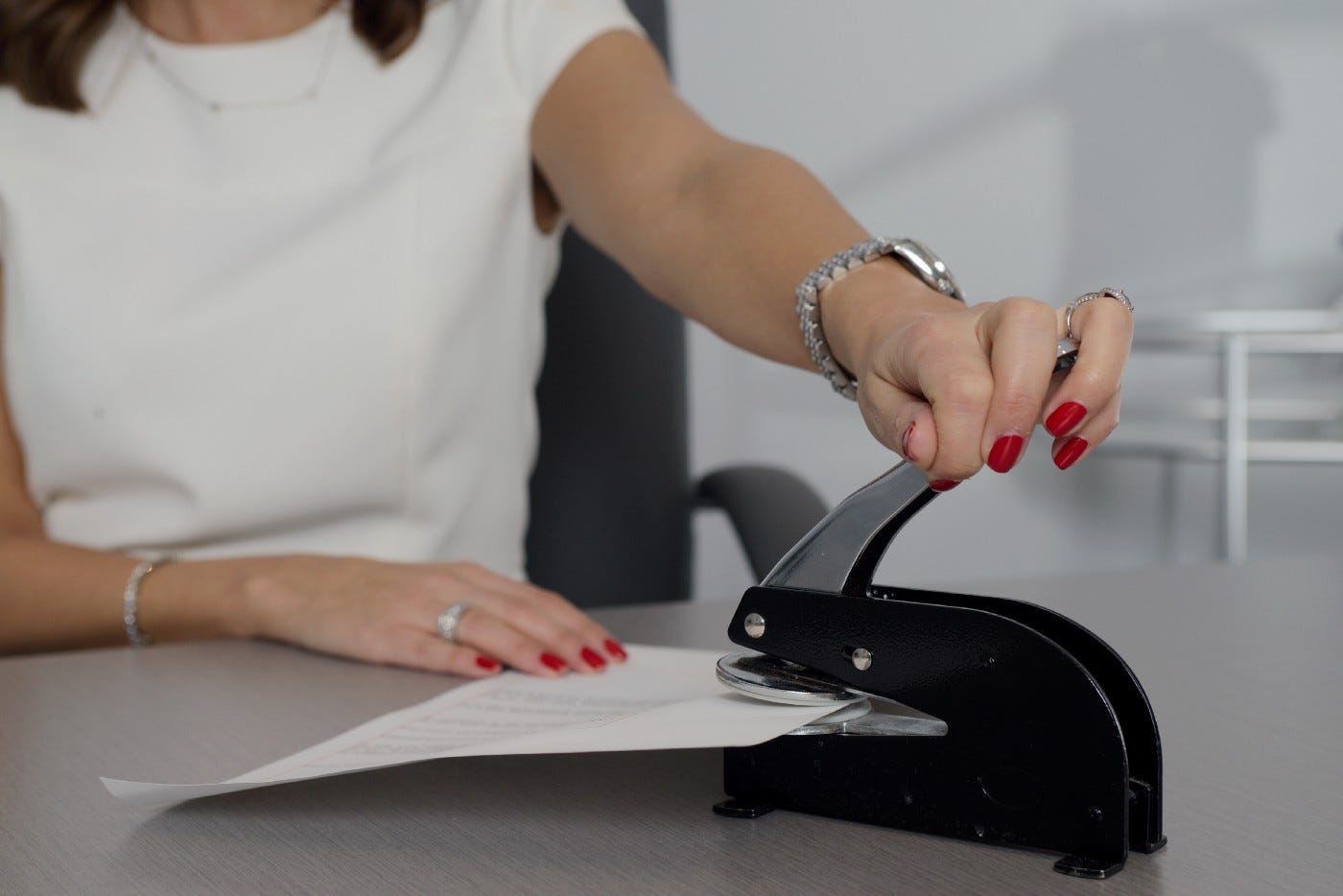 Picture of a woman embossing a document
