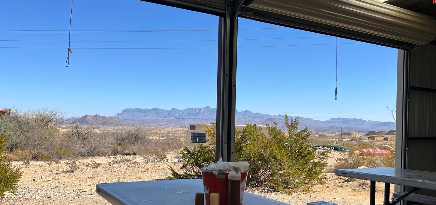 A view of the desert from a window

Description automatically generated