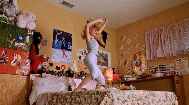 This may contain: a woman standing on top of a bed in a room with lots of clutter This may contain: a woman standing on top of a bed in a room with lots of clutter