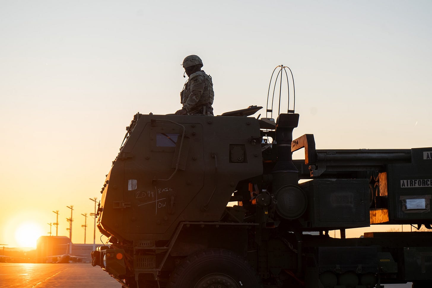 U.S. Army Staff Sgt. Zykee Allen, assigned to 3rd Battalion, 321st Field Artillery Regiment, sits atop an M142 High Mobility Artillery Rocket System (HIMARS) to receive a fire mission during a training mission at Ramstein Air Base, Germany, on March 27, 2025. 