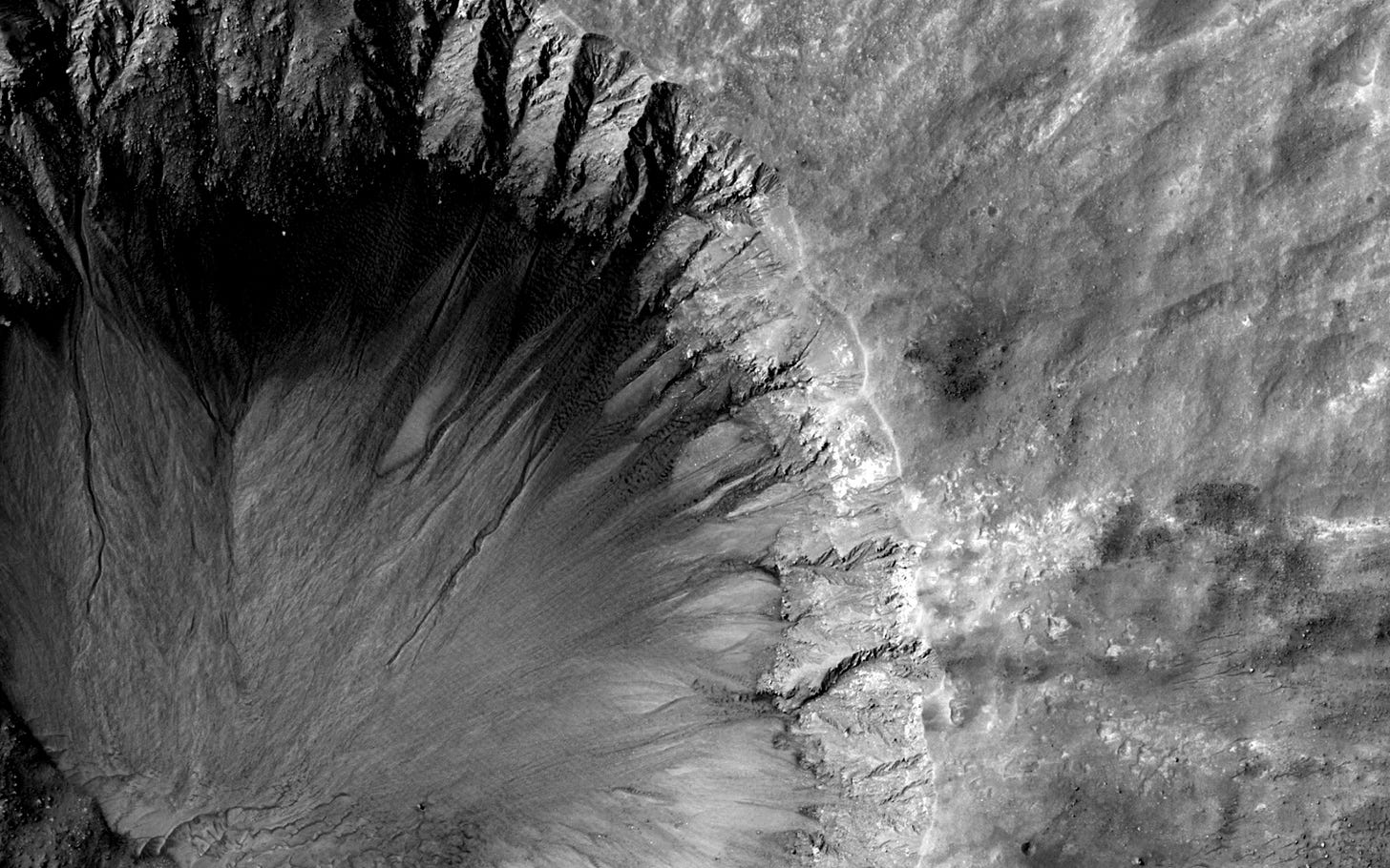 a large crater in the middle of a desert