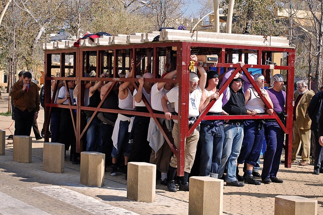 Colour photograph of Costaleros practicing on the Alameda de Hércules in Seville, 2010.