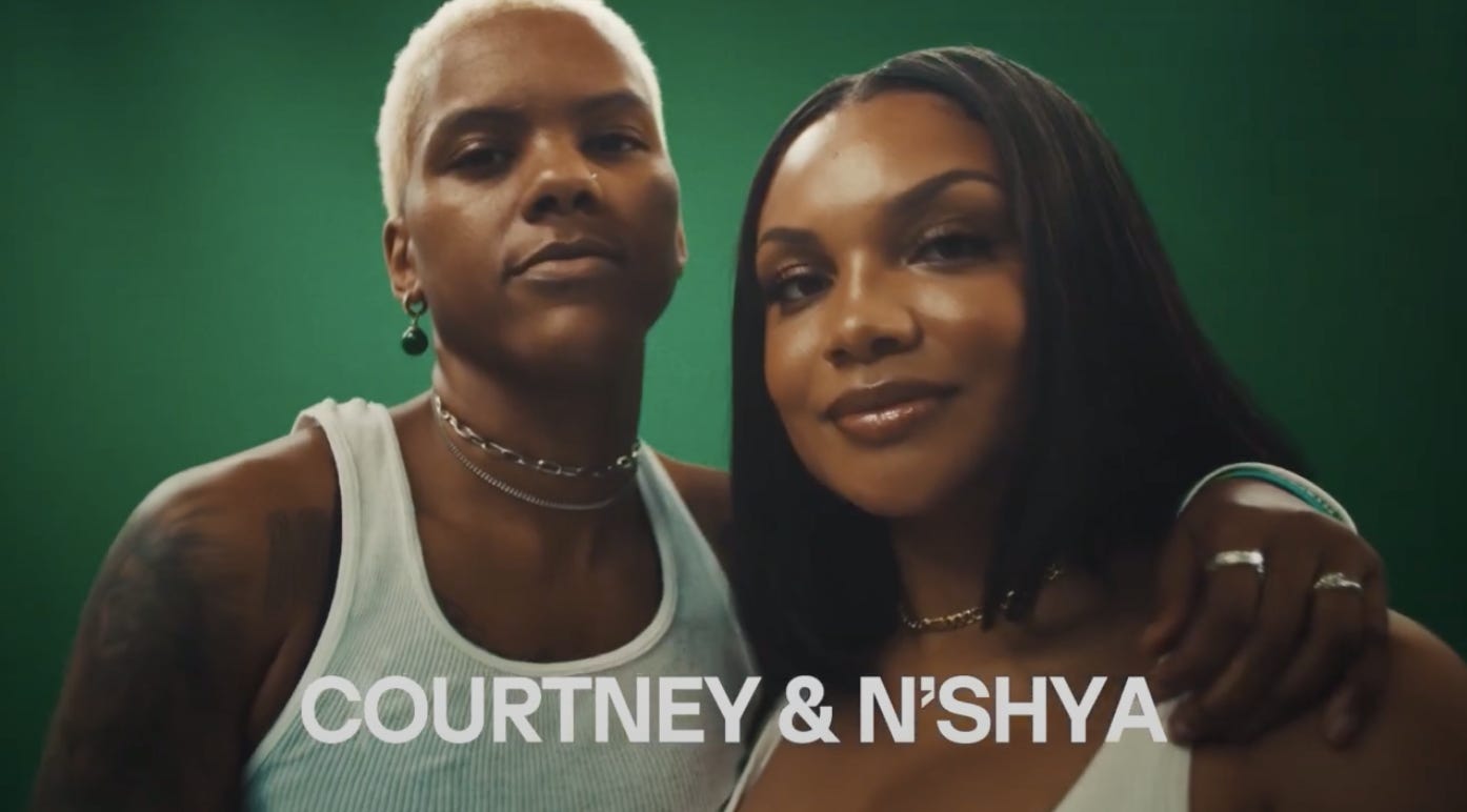 Courtney Williams with her arm around her girlfriend N'Shya, both of them looking at the camera