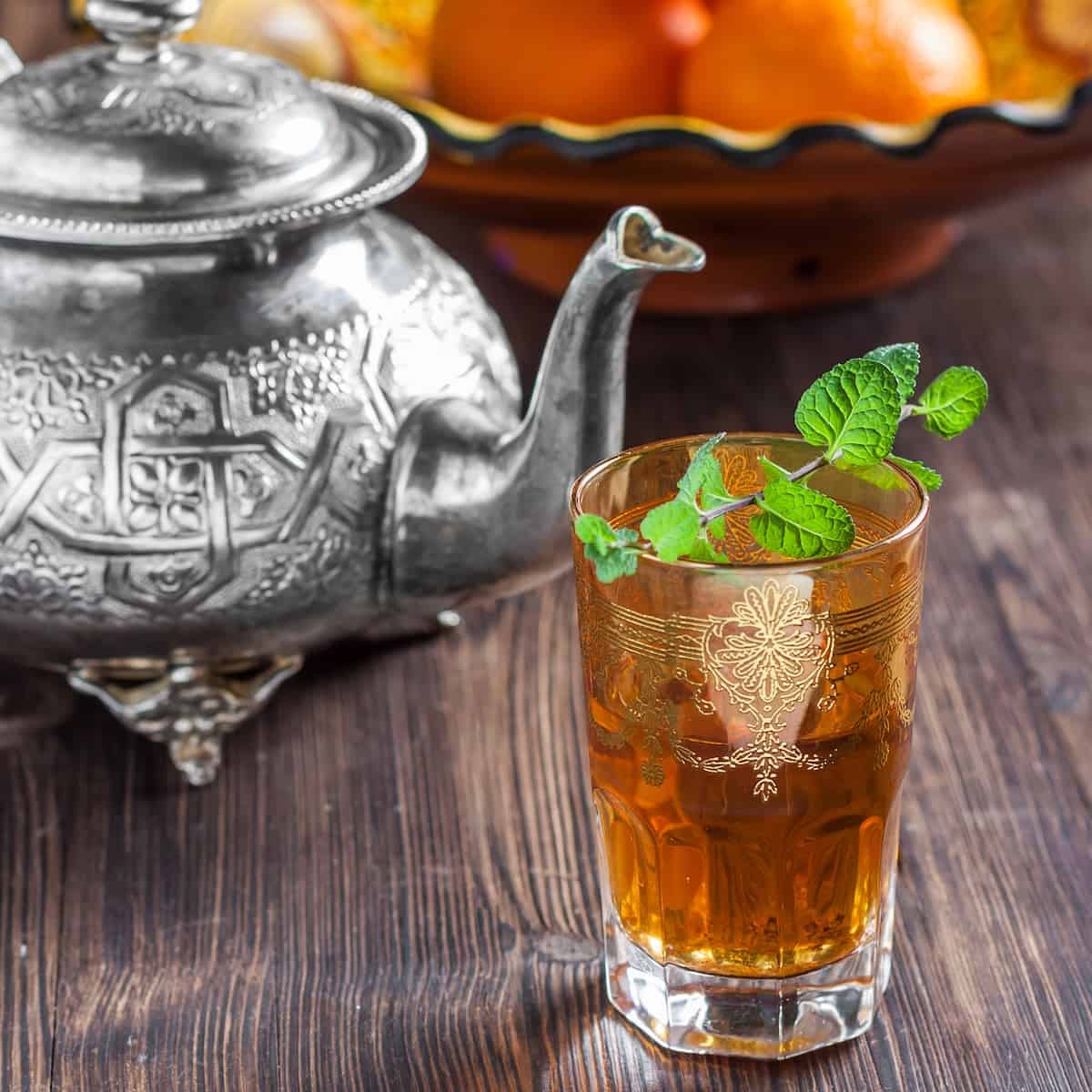 moroccan mint tea pot and glass with sprig of mint