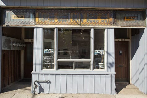 revealing the old hand painted sign at Black Cat Artspace