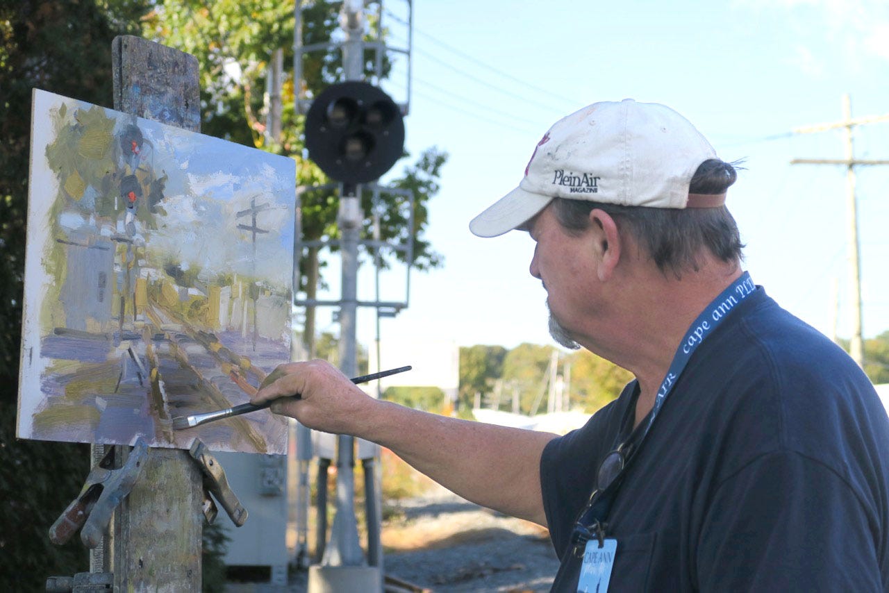 A person painting a picture

Description automatically generated