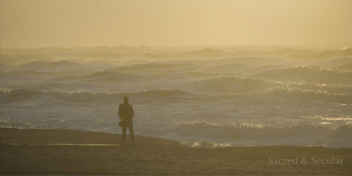 A lone silhouetted person stands on a beach looking across a rough, sunlit sea beneath a warm golden sky, conveying reflection, uncertainty, and quiet hope. A lone silhouetted person stands on a beach looking across a rough, sunlit sea beneath a warm golden sky, conveying reflection, uncertainty, and quiet hope.